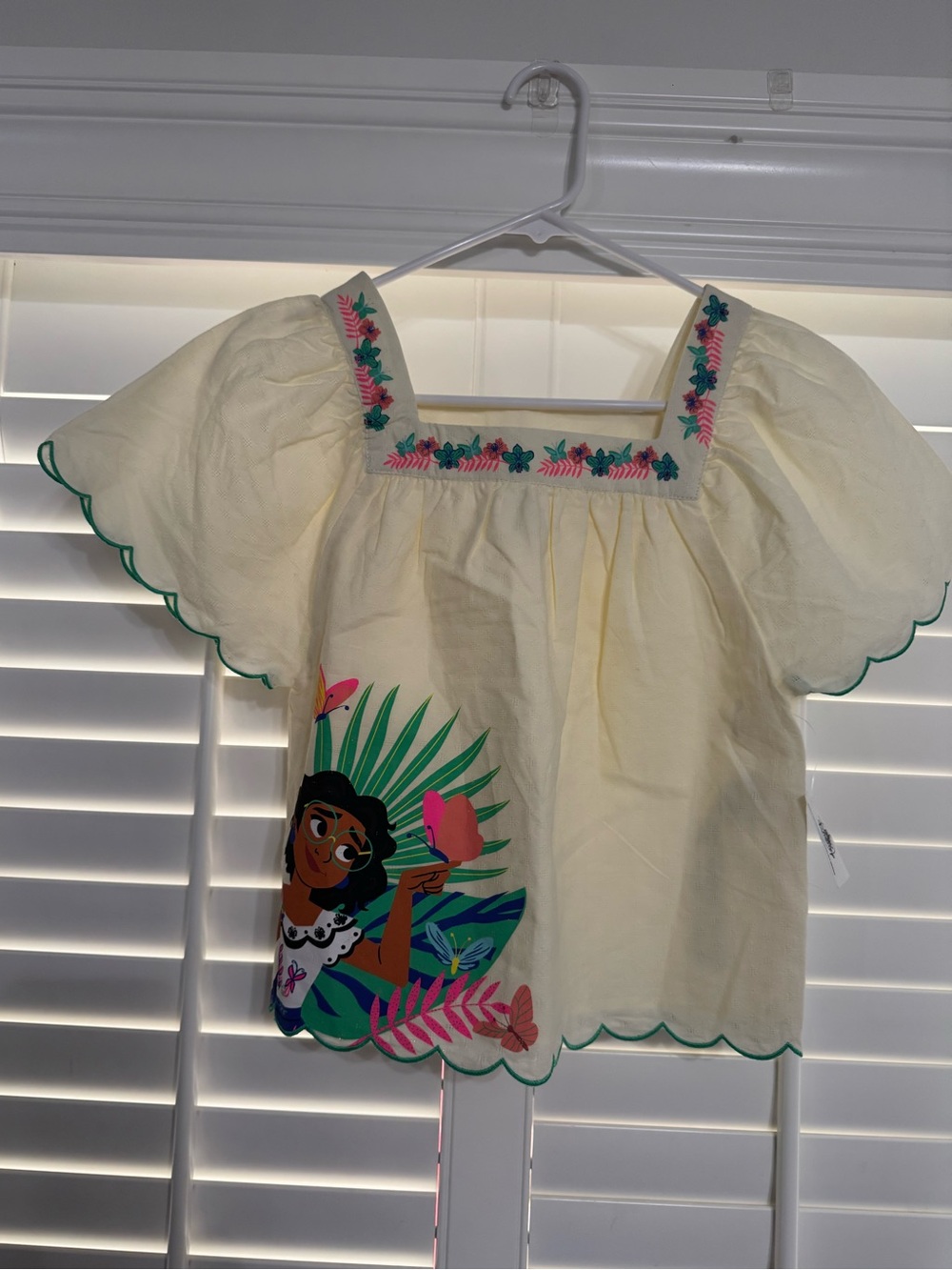 Disney Mirabel-Encanto. Cream Flutter Sleeve Embroidered Tropical Top